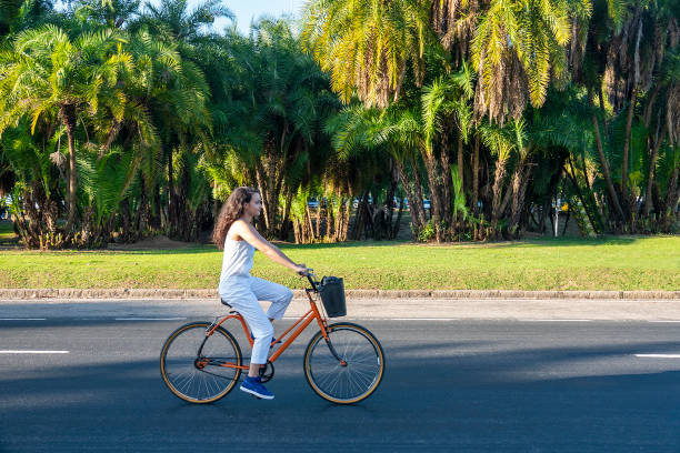 istock Young white woman drives the bicycle in a park 1338145478