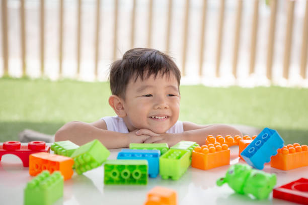 Little boy happy with his colorful plastic block toy