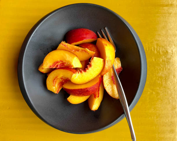 istock Sliced Nectarines in Black Bowl with Fork, Ready-to-Eat 1338148423