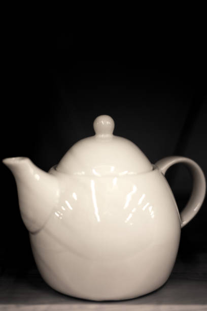 istock White Teapot Black Background Close-Up 1338149240