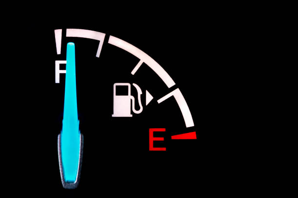 Fuel gauge on dashboard of car. Fuel economy, carbon footprint and price of gasoline concept stock photo