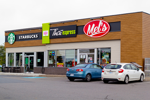 Truro, Canada - September 01, 2021: Starbucks coffeehouse, Thai Express restaurant and Mel's convenience store.