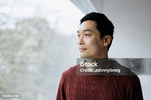 istock Close-up of relaxed early 40s Chinese man looking at view 1338162783
