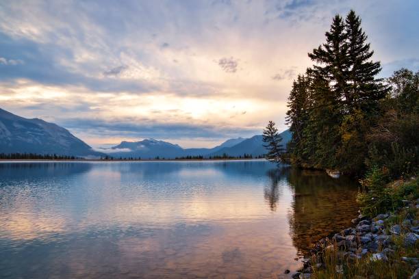 istock Cloudy Sunrise Reflecting On A Canmore Lake 1338164630