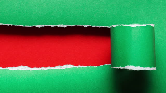 4k : stop motion of paper is torn over green background, christmas concept