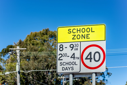 School zone road sign with speed limit 40 during before and after school hours in NSW, Australia. Road safety concept