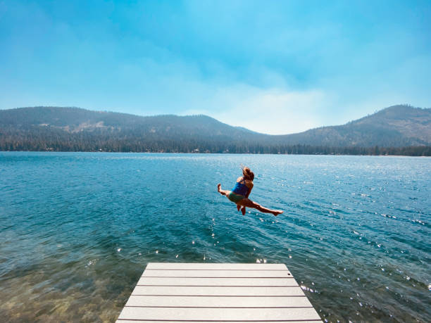 istock Jumping off a dock into a beautiful lake 1338172396