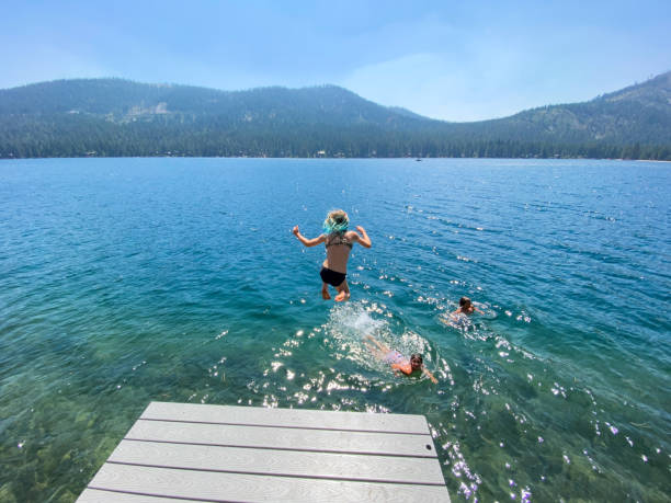 istock Jumping off a dock into a beautiful lake 1338172414