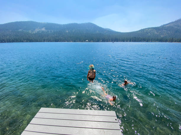 istock Jumping off a dock into a beautiful lake 1338172418