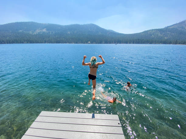 istock Jumping off a dock into a beautiful lake 1338172424