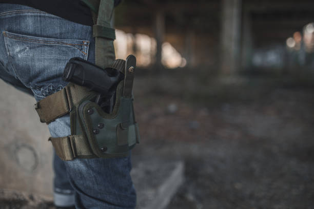 istock Armed mercenary with gun in war zone 1338173136