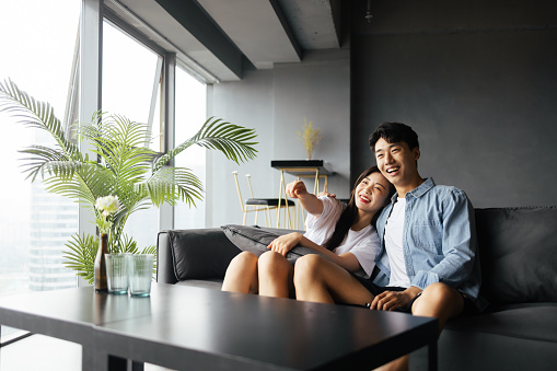 Young couples watch TV at home