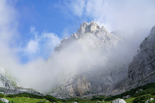 Mountain peak coming out from clouds during trekking in Julian Alps, Slovenia.