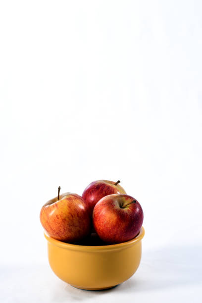 Apples in a basket with greens