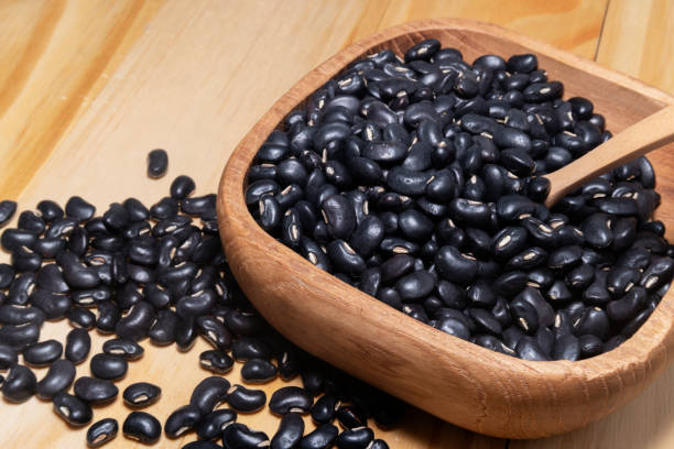 istock Black gram in wooden bowl isolated on white background. 1338180709