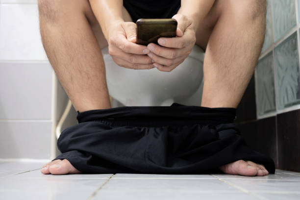 istock Guy play phone in the toilet. selective focus. 1338180732