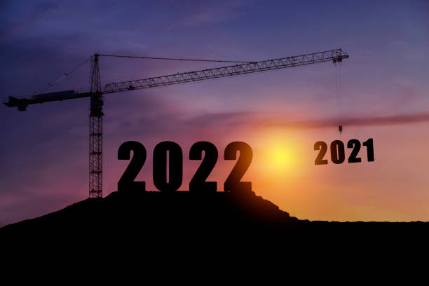 istock Silhouette of engineer and construction to create lifting crane 2022 on blue sky background. 1338182804