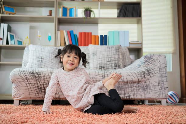 istock Little cute girl practicing yoga pose on a mat indoor 1338183600