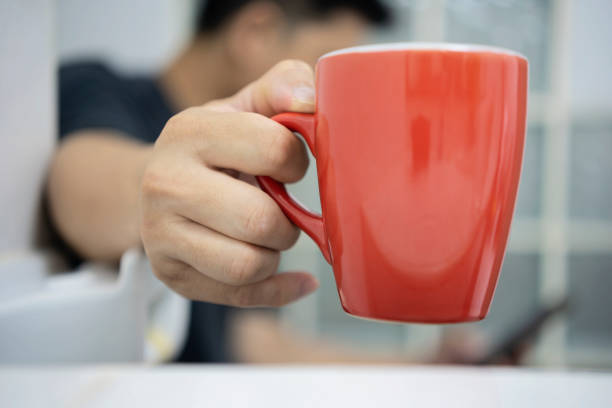 istock man sits on the toilet at home in the morning while drinking coffee. 1338187764
