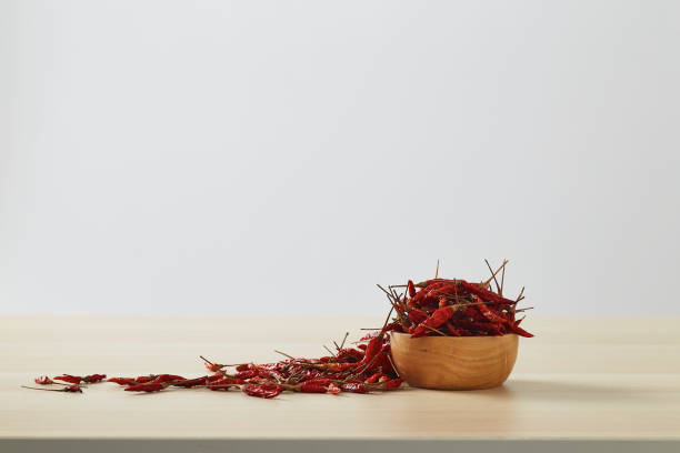 dried chili peppers in a wooden bowl placed on a wooden table - 2281 imagens e fotografias de stock