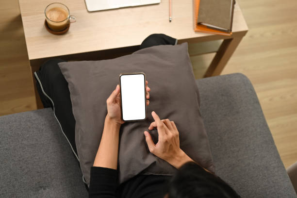 istock Man sitting on sofa and surfing internet with smart phone. 1338191282