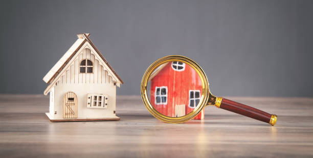 istock Magnifying glass with a house model. Real estate. Inspection 1338202696