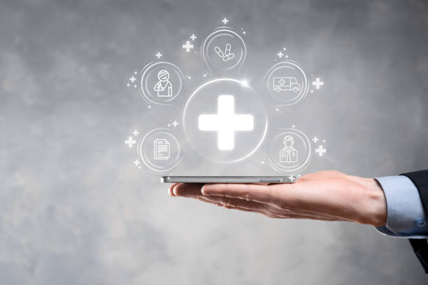istock Businessman hold virtual plus medical network connection icons. Covid-19 pandemic develop people awareness and spread attention on their healthcare.Doctor,document,medicine,ambulance,patient icon. 1338209220