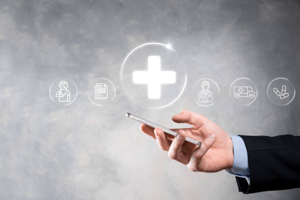 istock Businessman hold virtual plus medical network connection icons. Covid-19 pandemic develop people awareness and spread attention on their healthcare.Doctor,document,medicine,ambulance,patient icon. 1338209222