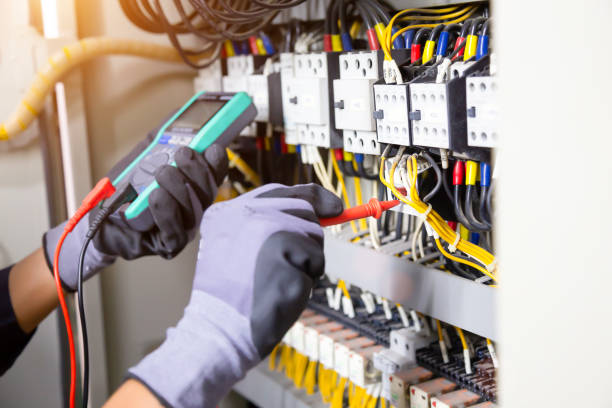 istock Electrician engineer tests electrical installations and wires on relay protection system. Adjustment of scheme of automation and control of electrical equipment. 1338210731