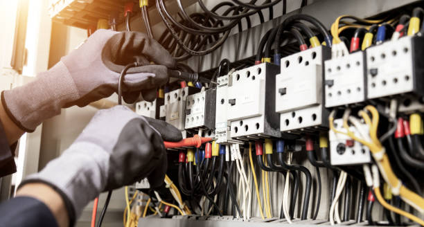 istock Electrician engineer tests electrical installations and wires on relay protection system. Adjustment of scheme of automation and control of electrical equipment. 1338210753