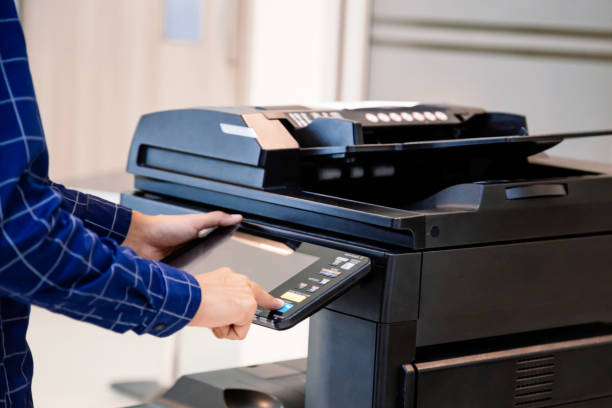 istock Businessmen press button on the panel for using photocopier or printer for printout and scanning document paper at office. 1338211740