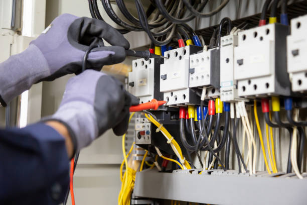 istock Electrician engineer tests electrical installations and wires on relay protection system. Adjustment of scheme of automation and control of electrical equipment. 1338211853