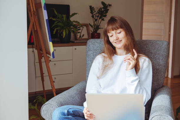 istock Young woman having online video chat conference from home. 1338212551