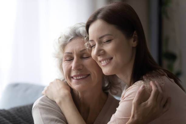 istock Happy grownup daughter and mature mom hugging 1338215534