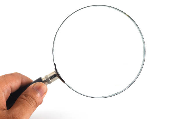 istock Magnifying glass with hand holding it isolated on white background 1338219331