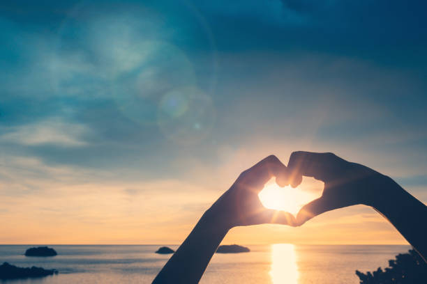 istock nature background and heart shaped hands 1338220948