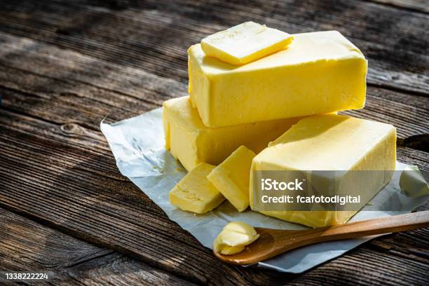 Butter Blocks And Pieces On Wooden Table Copy Space Stock Photo - Download Image Now