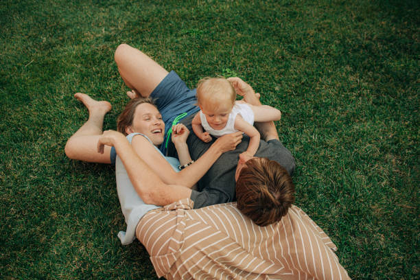 istock Happy family resting together on front yard 1338225015