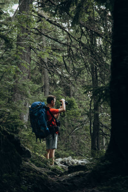istock A backpacker take a picture on his camera in the mountains 1338227615