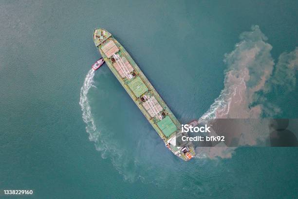 Top View Of Freight Ship Approaching Port With Tugboat Stock Photo - Download Image Now