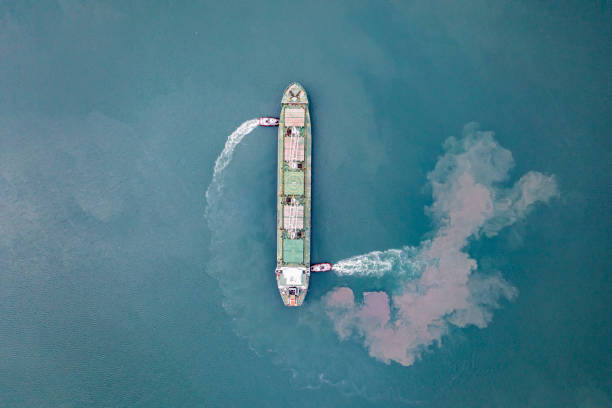 istock Top view of Freight Ship approaching port with tugboat. 1338229188