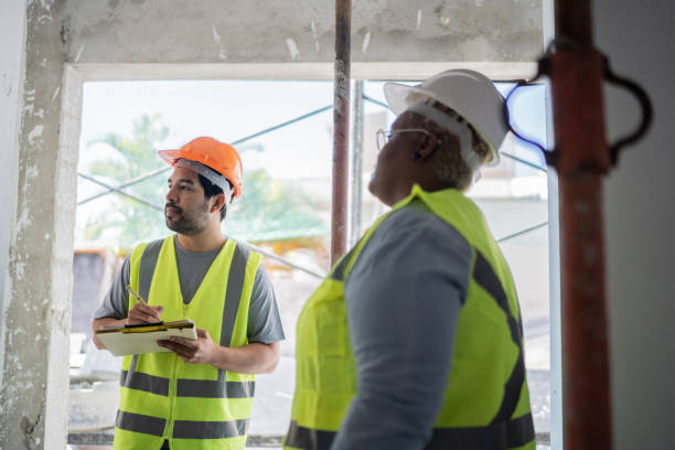 istock Coworkers doing a meeting in a construction site 1338237681