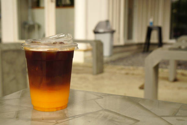 Beverage - Ice Espresso orange is iced black coffee with orange juice on the table at coffee cafe Beverage - Ice Espresso orange is iced black coffee with orange juice on the table at coffee cafe blended drink photos stock pictures, royalty-free photos & images