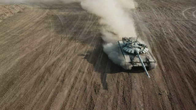 Aerial View - heavy tank moves off-road