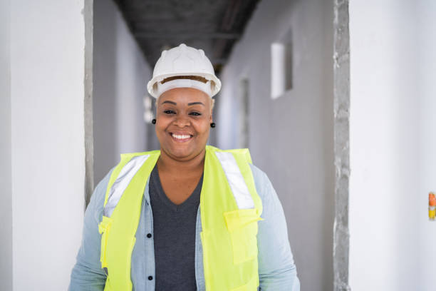 istock Portrait of a happy construction worker at a construction site 1338238533