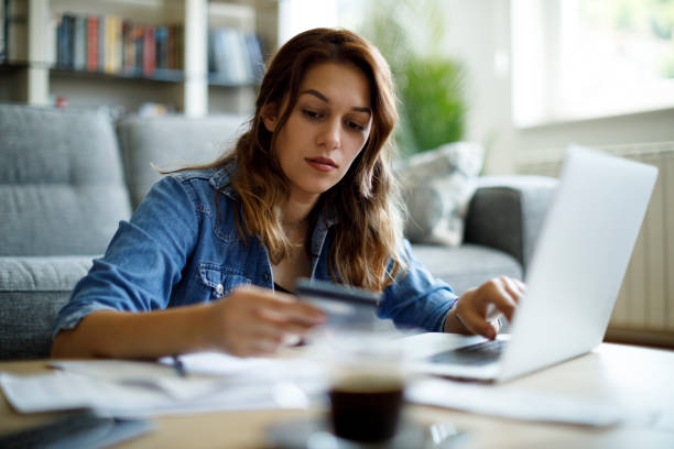 istock Woman paying bills with credit card 1338240166