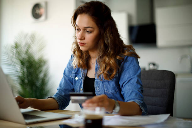 istock Woman paying bills with a credit card 1338240175