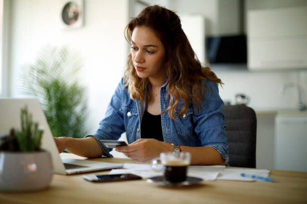 istock Woman paying bills with a credit card 1338240186