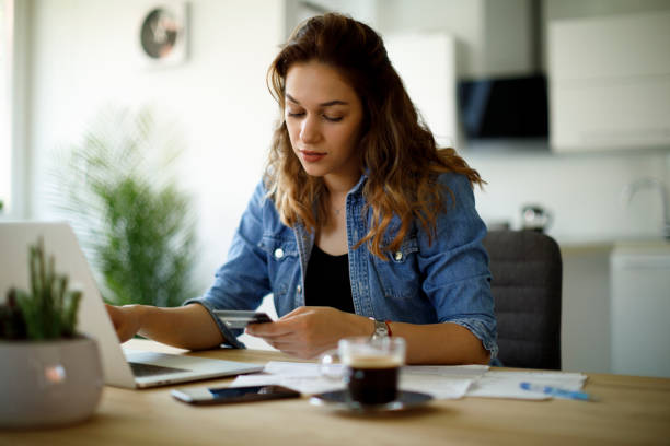 istock Young woman paying bills with credit card 1338240201
