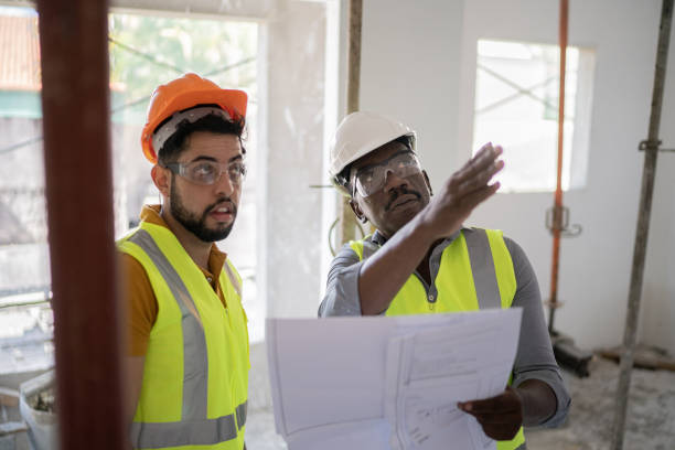 istock Coworkers doing a meeting in a construction site 1338240690